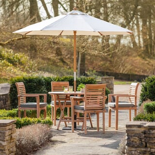 Bramblecrest Richmond 110cm Round Folding Table with 4 Stacking Armchairs Seat Cushions Parasol And Base