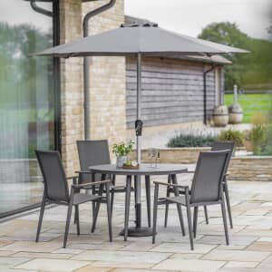 Bramblecrest Sofia 110cm Round Table with 4 Stacking Armchairs Parasol And Base Anthracite