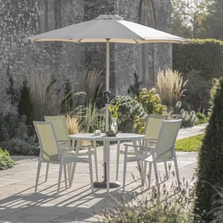 Bramblecrest Sofia 110cm Round Table with 4 Stacking Armchairs Parasol And Base Green