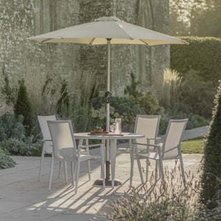 Bramblecrest Sofia 110cm Round Table with 4 Stacking Armchairs Parasol And Base Grey