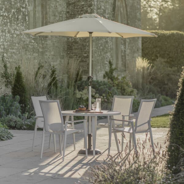 Bramblecrest Sofia 110cm Round Table with 4 Stacking Armchairs Parasol And Base Grey