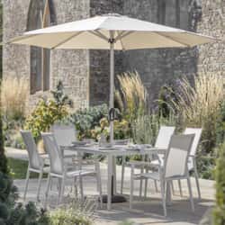 Bramblecrest Sofia 165 x 95cm Rectangle Dining Table with 6 Stacking Armchairs Parasol And Base In Grey